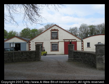 A white building with red trim at the Kerry Woolen Mills.