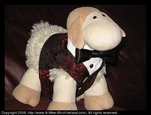 Curious Sheep is a stuffed toy sheep. Curious Sheep is wearing a tuxedo.