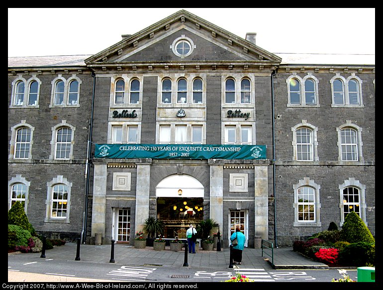 A three story stone building with the words Belleek Pottery and Celebrating 150 Years of Exquisite Craftmanship 1857-2007.
