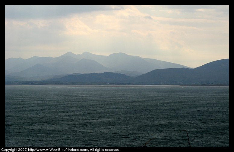 A view across a bay with mountains in the distance.