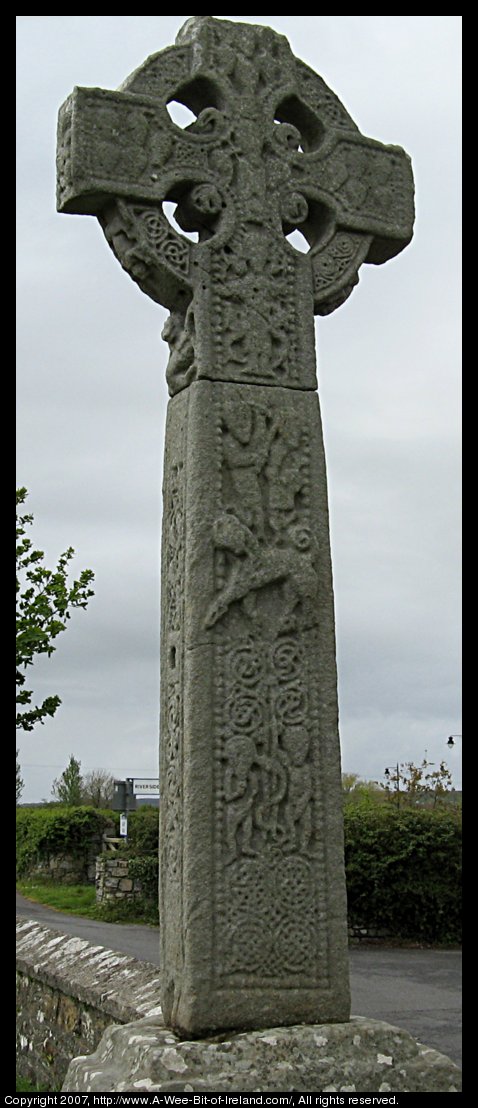 A celtic high cross carved from sandstone with celtic knots and images from the Bible. It is over 12 feet tall including the pedestal that it rests upon.
