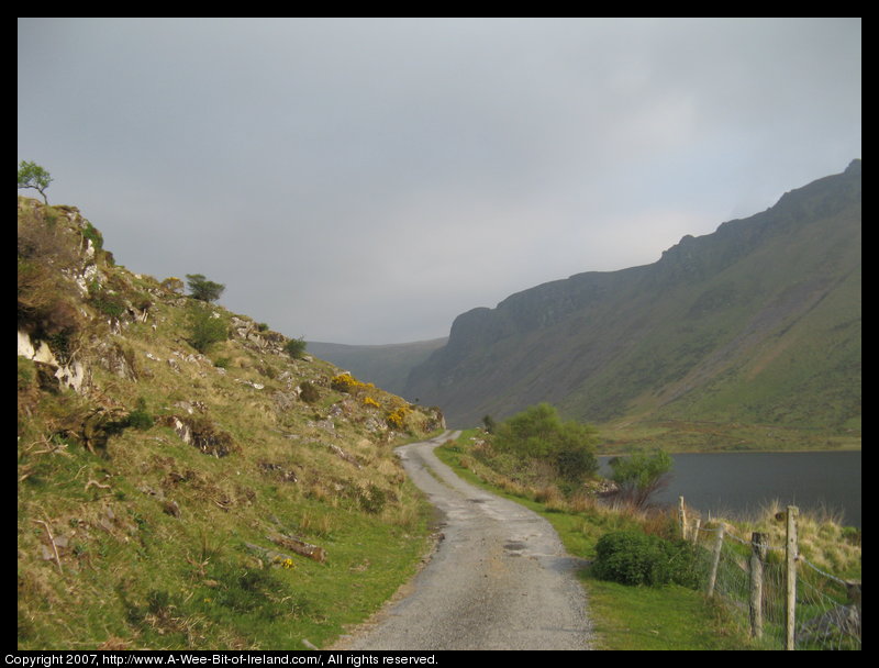 There is a narrow one lane road along a steep rocky hillside next to Lough Anscaul