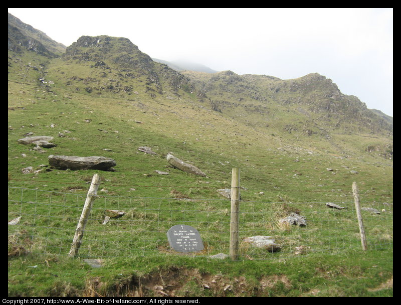A memorial stone that says "In Memory of Philippe Lavene, France, aged 19 years, died in a fall on 18-8-1975, R.I.P."