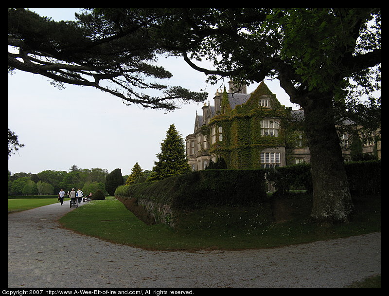 17th century manor house surrounded by tall trees.