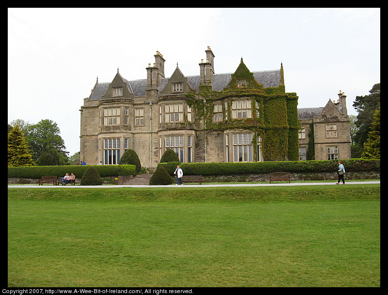 17th century manor house surrounded by tall trees.