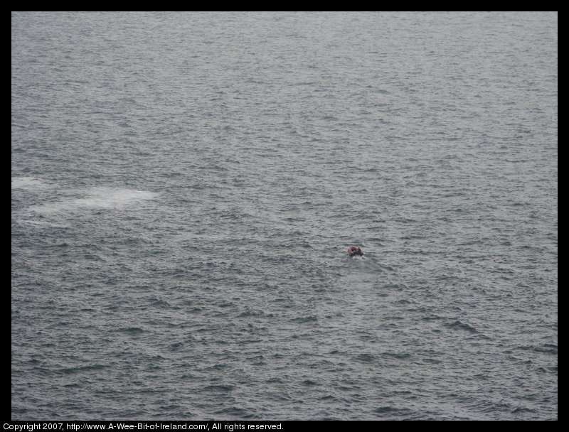 A small boat is surrounded by ocean.