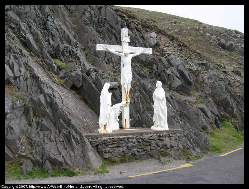 A crucifix with a backdrop of stones.