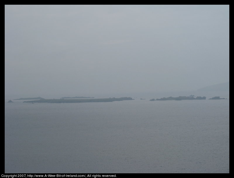Islands barely visible through haze and ocean spray from Slea Head Scenic Drive