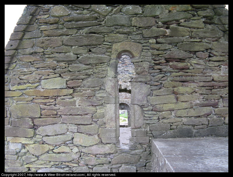 Carved stone and stone arches in ruined church.