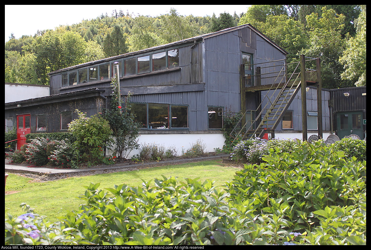 A corrogated steel building with nice landscaping.