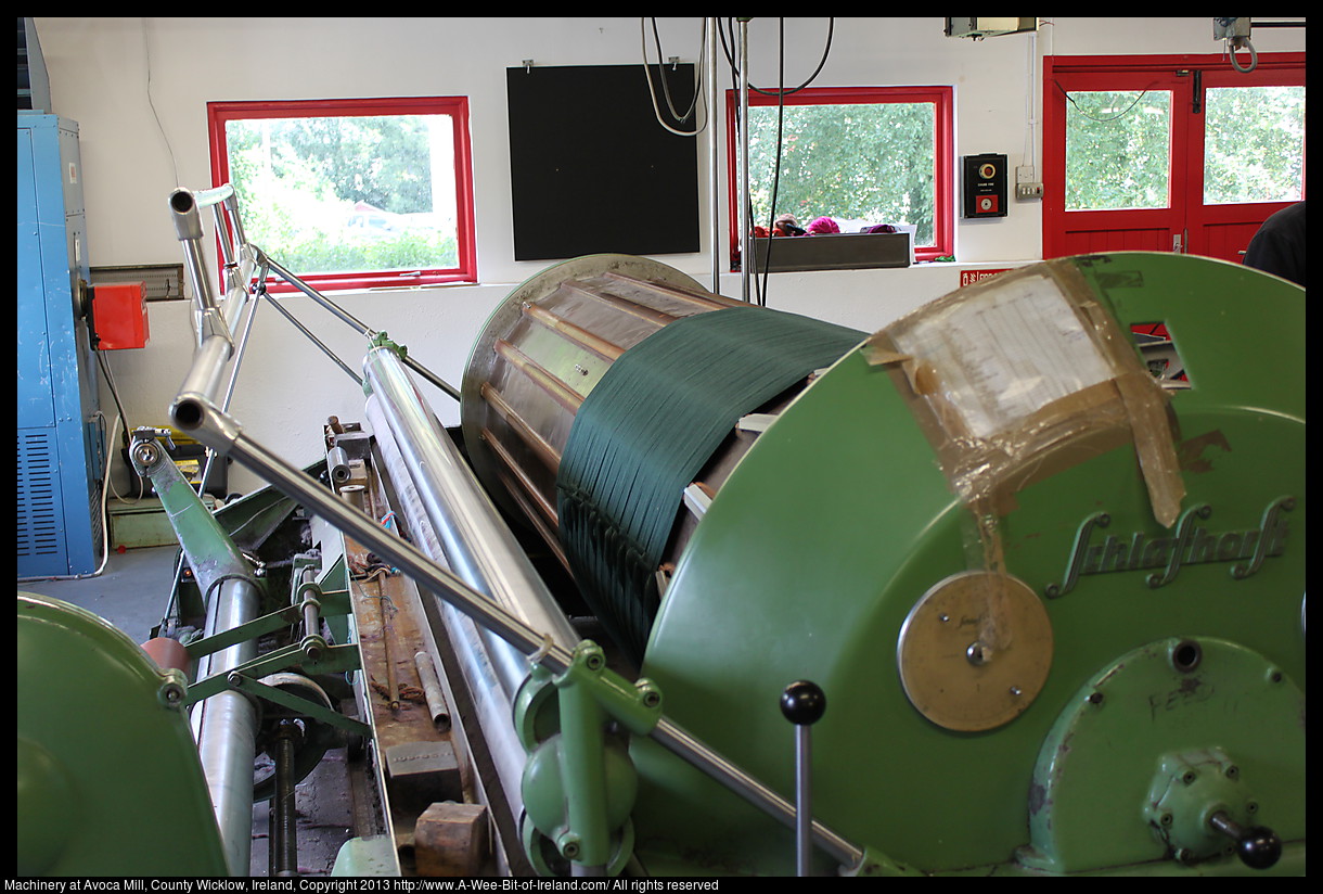 Large machinery weaving cloth.