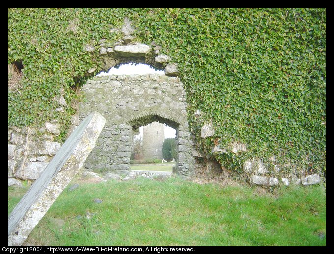 Clomantagh Castle Seen Through Ruins of Church
