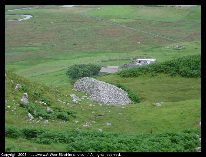 A mound of gray stones on a mountain side.