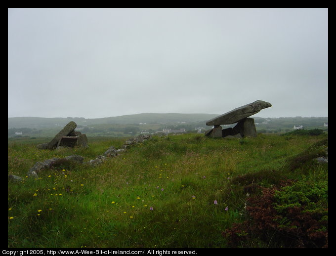 Kilclooney More Dolmen in County Donegal. A rock the size of a small
 automobile has been placed on top of standing stones about 6000 years ago
 and another smaller such megalithic monument to the left.