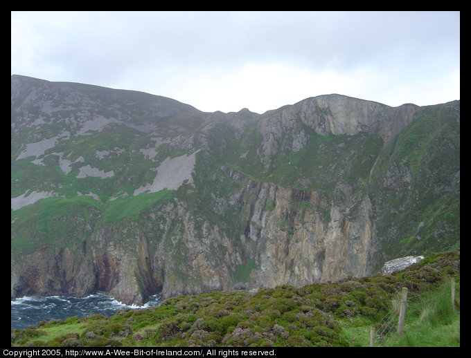 Slieve League sea cliffs. A bit of fence is in the foreground.